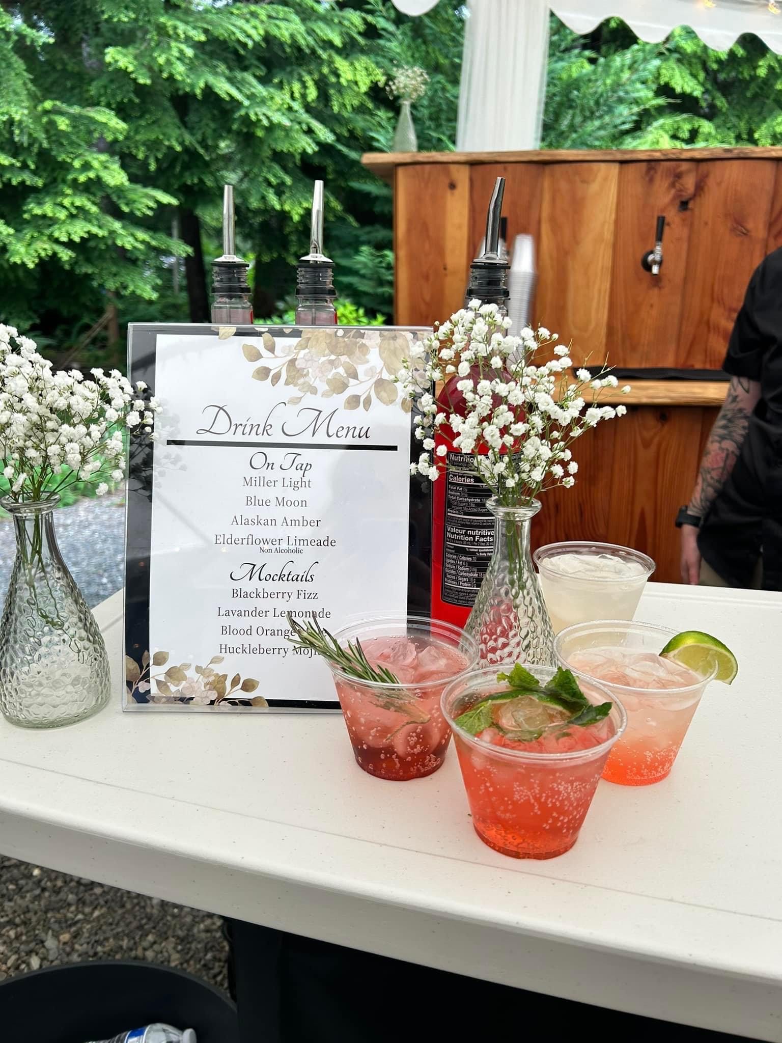 holiday cocktails with a drink menu and flowers
